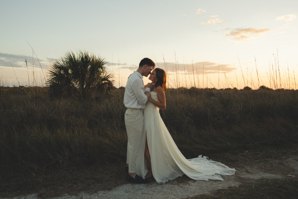 bride and groom kissing on Fort Desoto beach for their Tampa bay engagement photos.