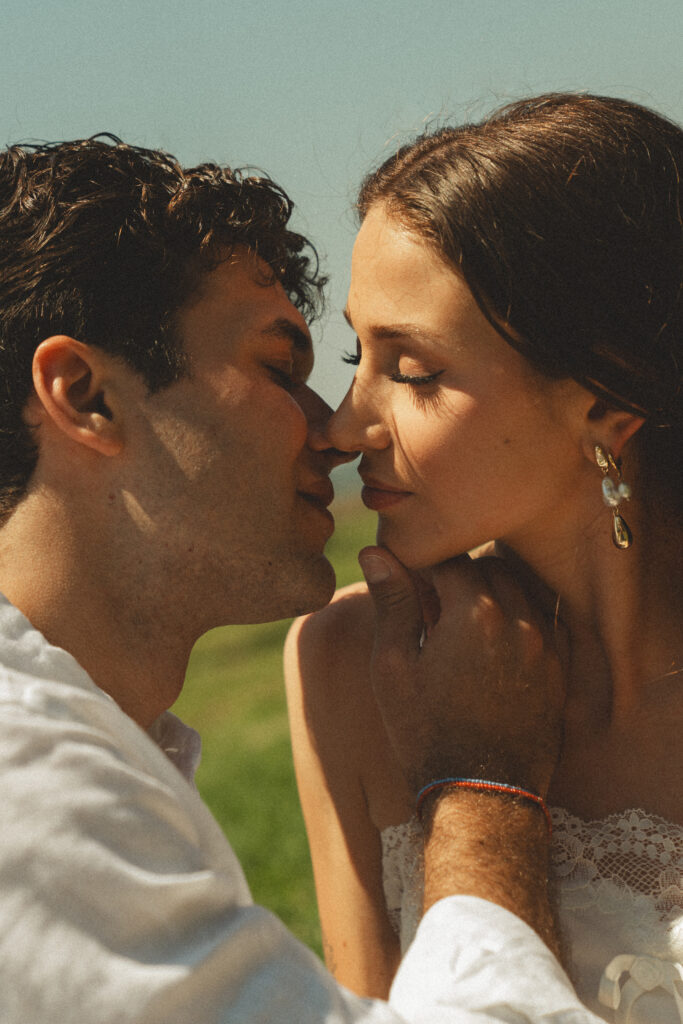 creative wedding portrait of bride and groom sharing a kiss during their engagement photos at the Ringling museum