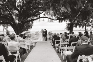 bride and groom bowing their heads at the altar during their wedding ceremony at Bella Cosa wedding Venue in Florida