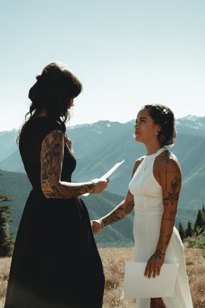 bride reading her vows on top of a mountain in Olympic national park