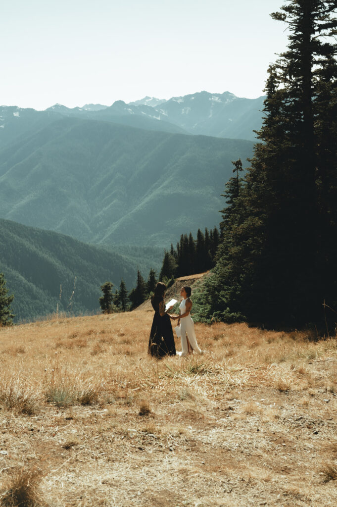 Two women hand-in-hand on a mountain in Olympic national park
