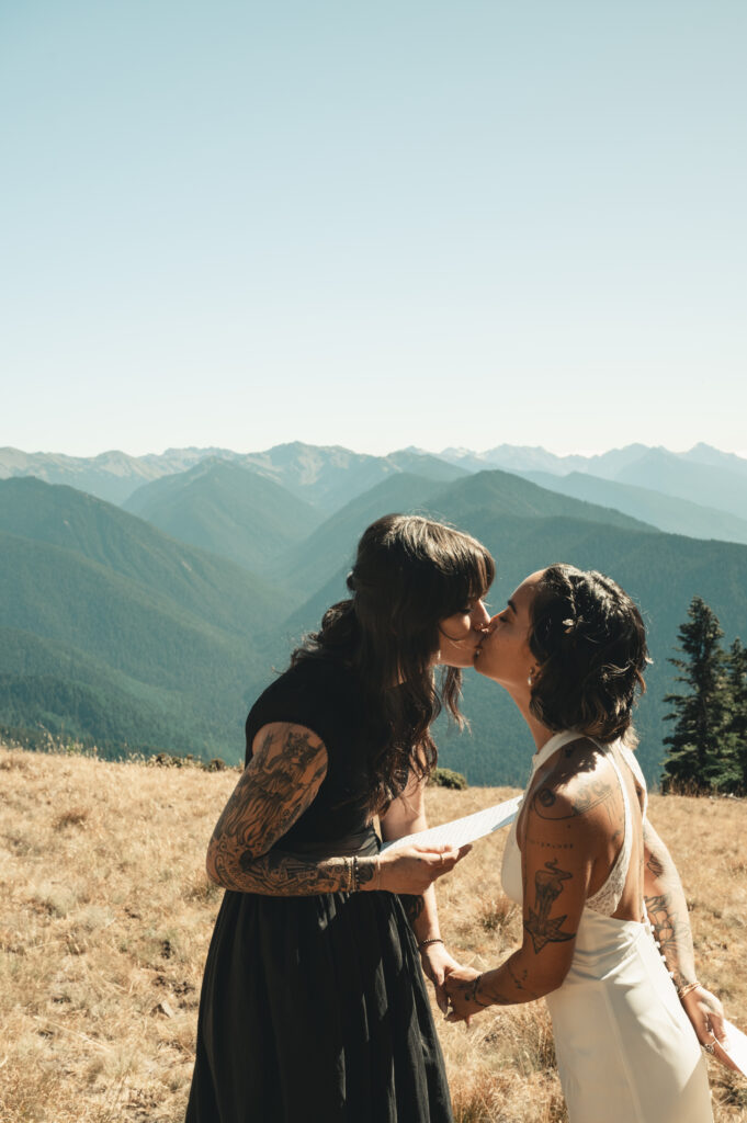 two brides share a kiss during their elopement ceremony on hurricane ridge