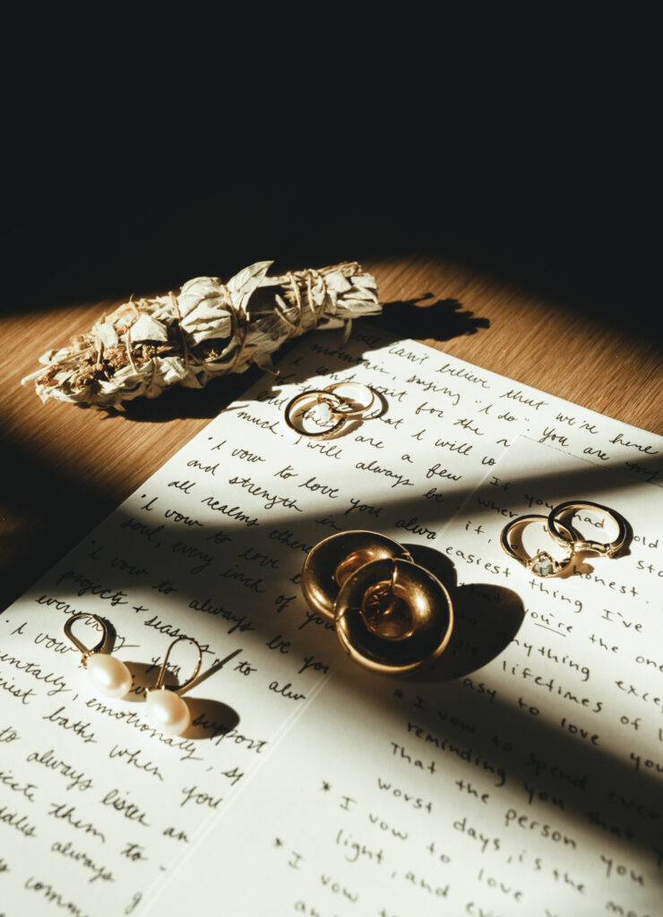 wedding details like vows and jewelry set up for a creative detail shot
