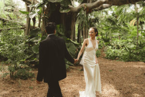 A couple walking hand in hand on their wedding day