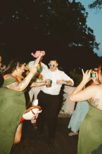 candid shot of bride dancing with her bridesmaids
