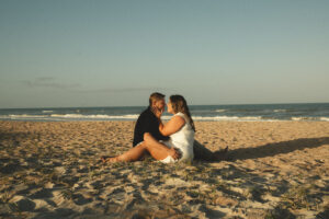 a couple sitting on St. Augustine beach touching nose to nose for their elopement photos